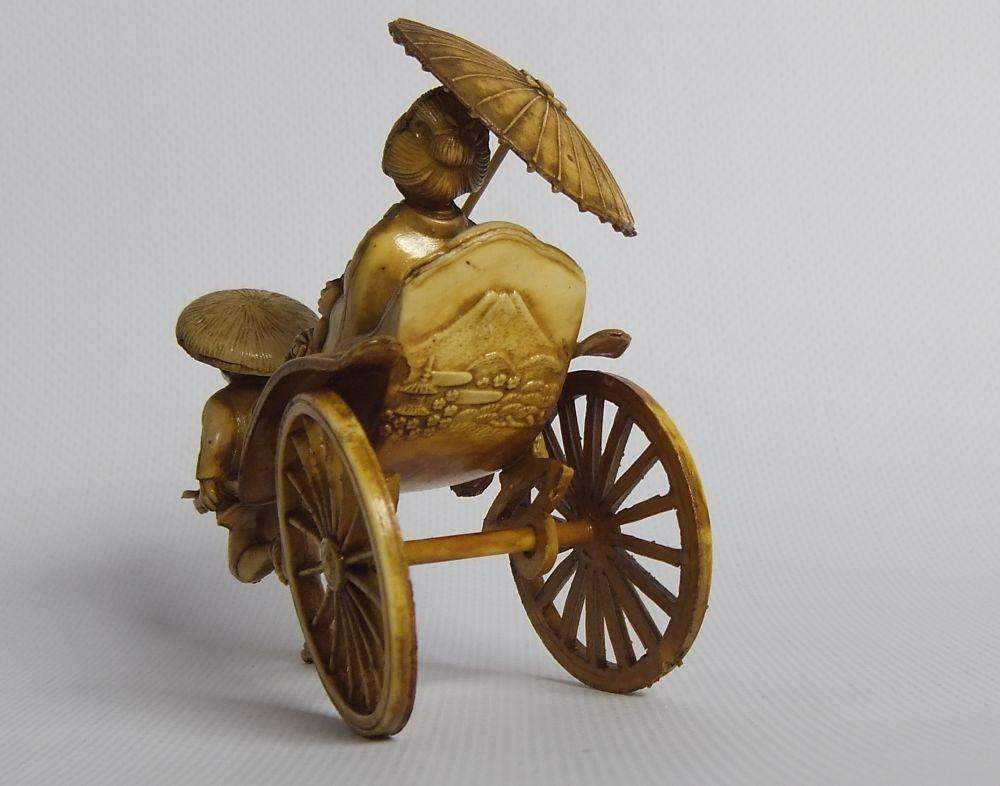 A HIGHLY DETAILED AND DELICATE VINTAGE JAPANESE CELLULOID RICKSHAW AND GEISHA ORIENTAL FIGURINE
