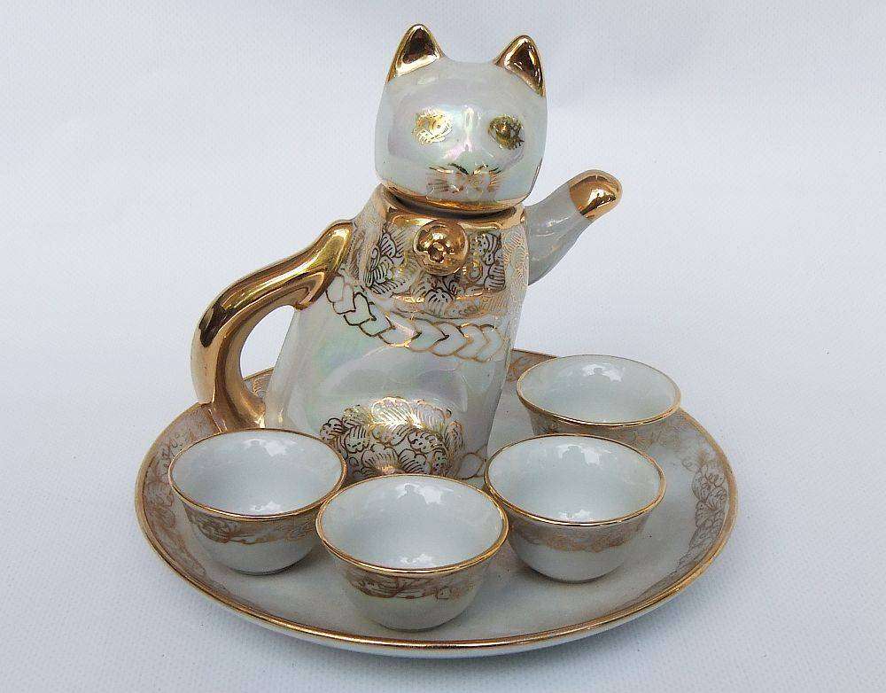 An adorable vintage hand painted porcelain kitty cat themed drink set with rainbow lustre