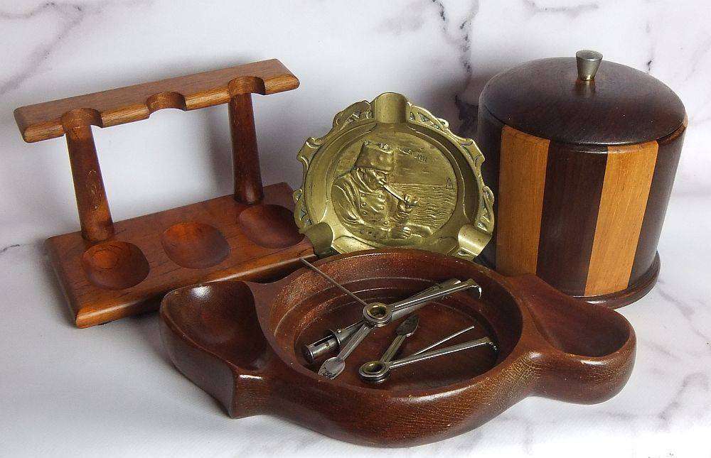 A grand assortment of vintage pipe smokers accessories including tobacco jar , pipe stand and more