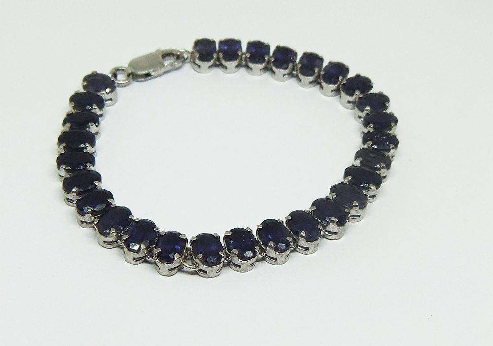 A gorgeous sterling silver bracelet with 28 faceted dark blue insets