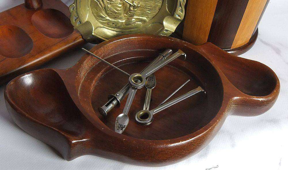 A grand assortment of vintage pipe smokers accessories including tobacco jar , pipe stand and more