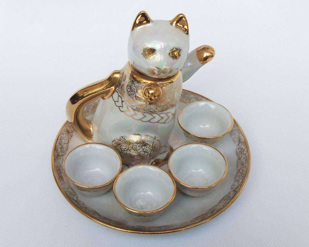 An adorable vintage hand painted porcelain kitty cat themed drink set with rainbow lustre