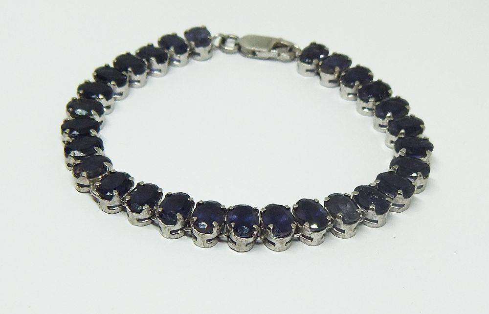 A gorgeous sterling silver bracelet with 28 faceted dark blue insets