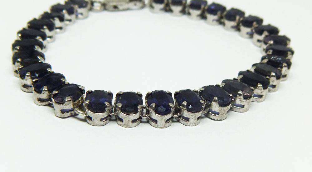 A gorgeous sterling silver bracelet with 28 faceted dark blue insets