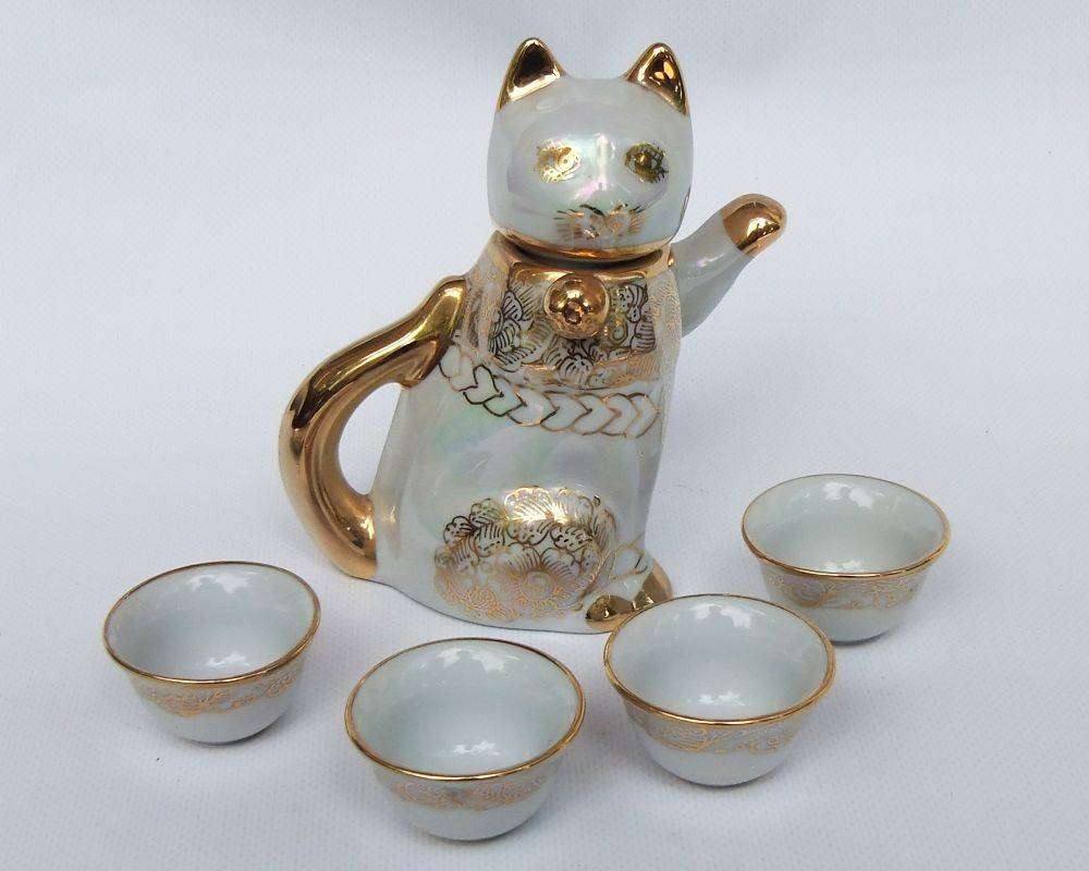 An adorable vintage hand painted porcelain kitty cat themed drink set with rainbow lustre
