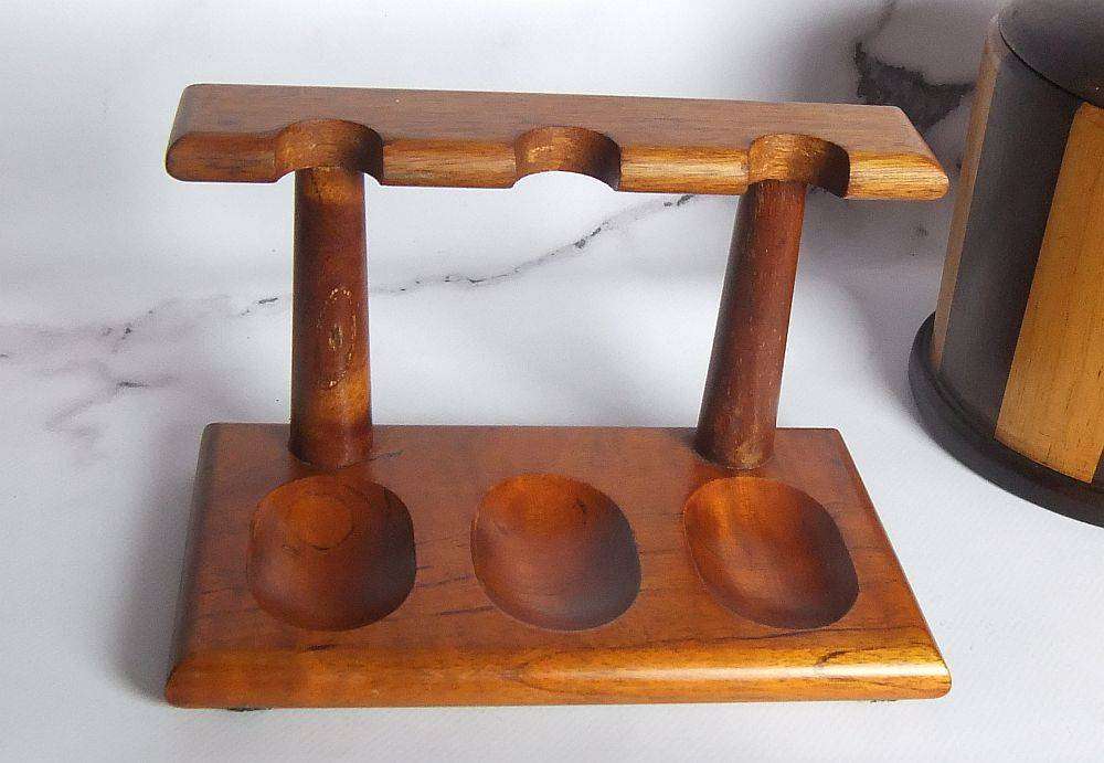 A grand assortment of vintage pipe smokers accessories including tobacco jar , pipe stand and more