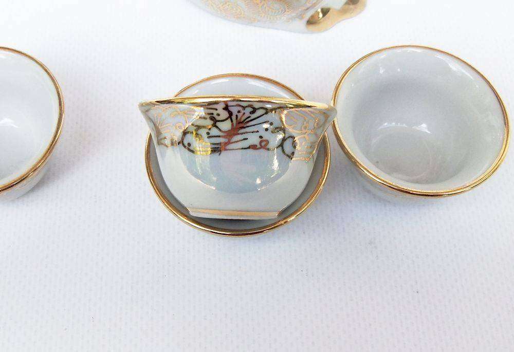 An adorable vintage hand painted porcelain kitty cat themed drink set with rainbow lustre