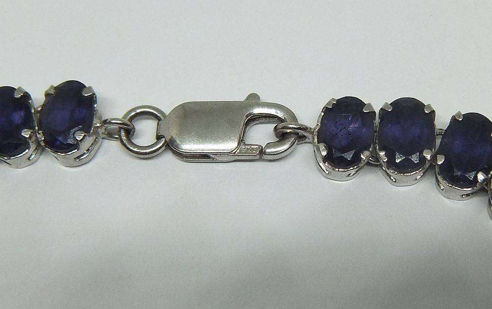 A gorgeous sterling silver bracelet with 28 faceted dark blue insets