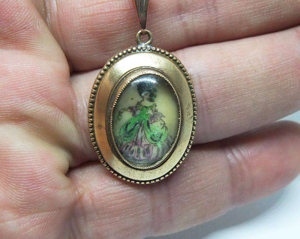 A lovely vintage rolled gold Thomas L Mott pendant with lady theme plus free plated necklace