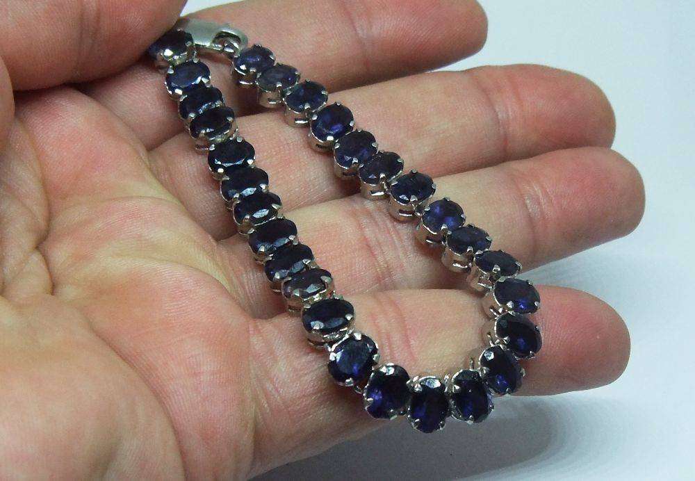 A gorgeous sterling silver bracelet with 28 faceted dark blue insets