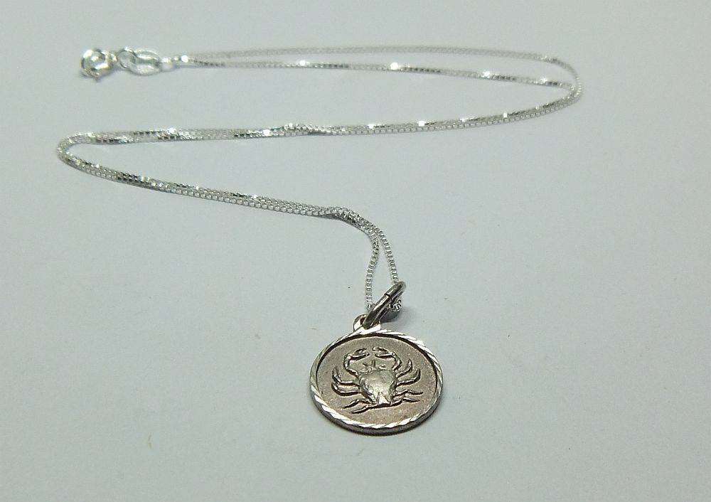 A vintage sterling silver Cancer Zodiac sign pendant plus a sterling silver necklace