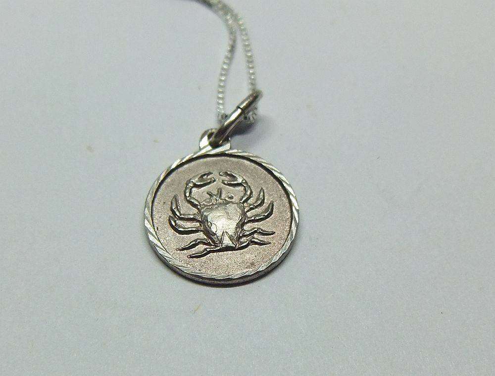 A vintage sterling silver Cancer Zodiac sign pendant plus a sterling silver necklace