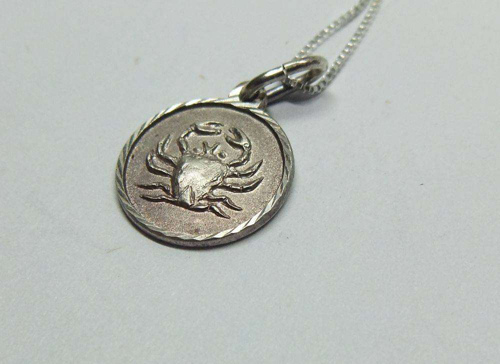 A vintage sterling silver Cancer Zodiac sign pendant plus a sterling silver necklace