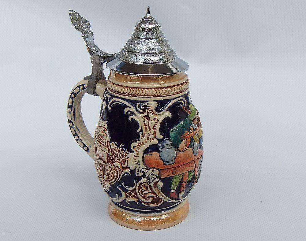A fabulous vintage German beer stein with hinged metal lid and great detail