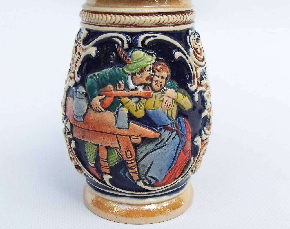 A fabulous vintage German beer stein with hinged metal lid and great detail