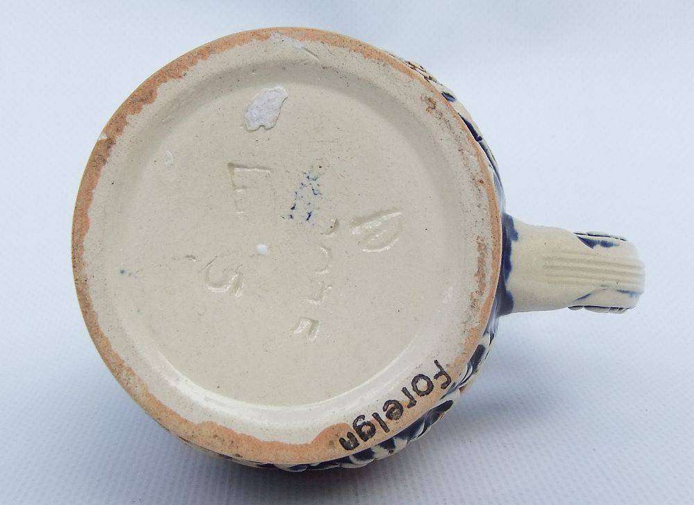 A fabulous vintage German beer stein with hinged metal lid and great detail