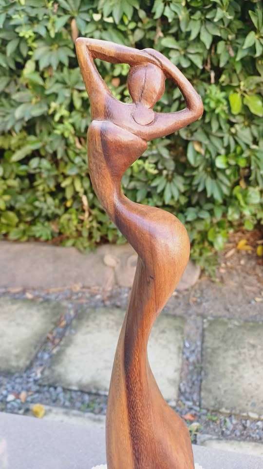 Elegant wooden abstract female figure on pedestal
