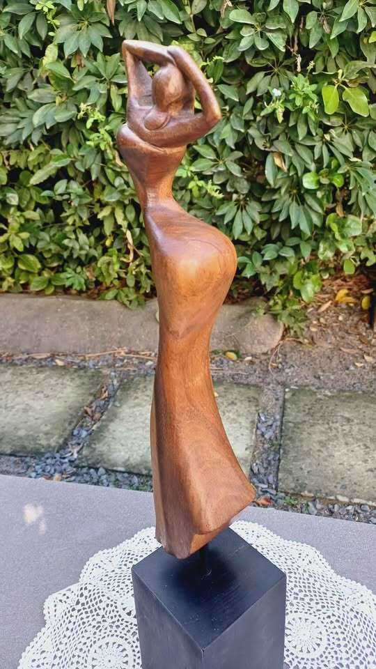 Elegant wooden abstract female figure on pedestal