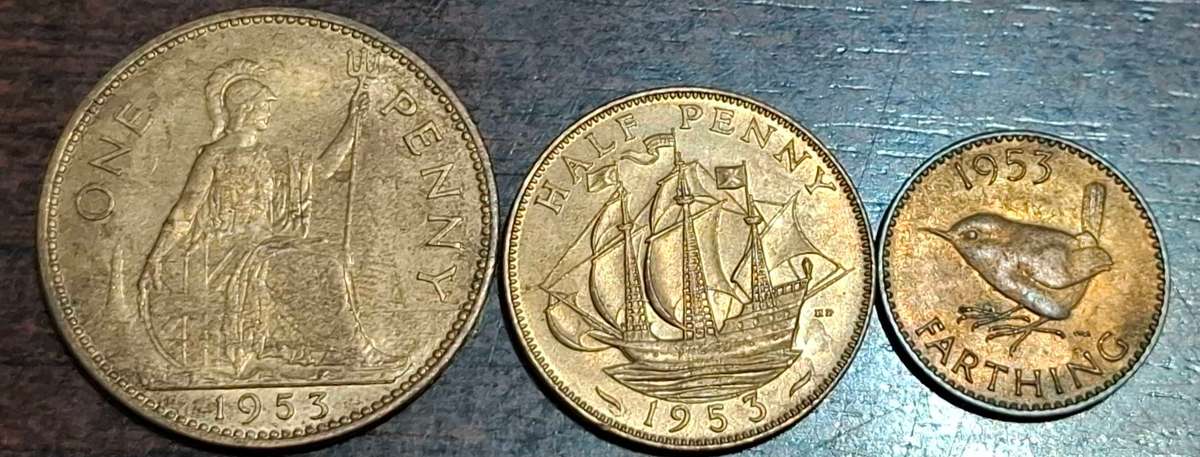 1953 three British pre-decimal coins: a One Penny, a Half Penny, and a Farthing
