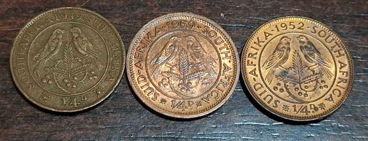 1/4 penny coins (also known as a farthing) from 1949, 1952, and 1960