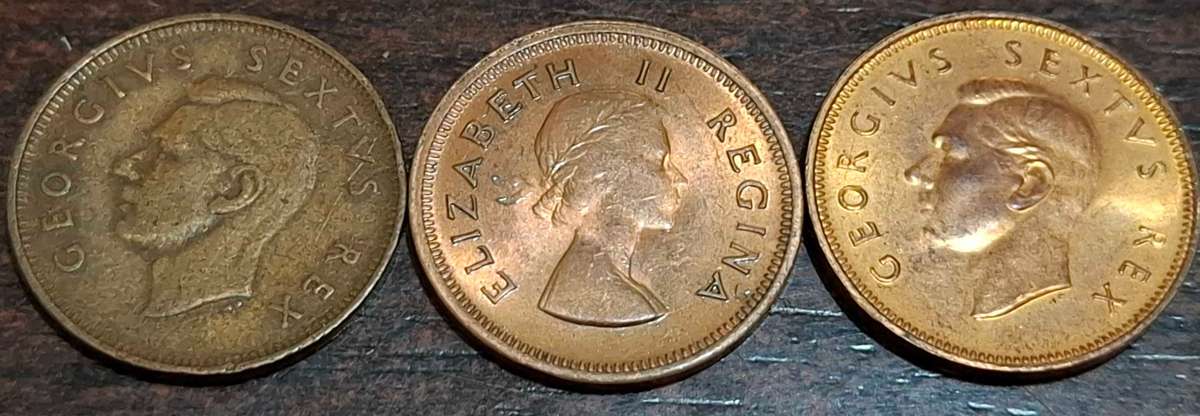 1/4 penny coins (also known as a farthing) from 1949, 1952, and 1960