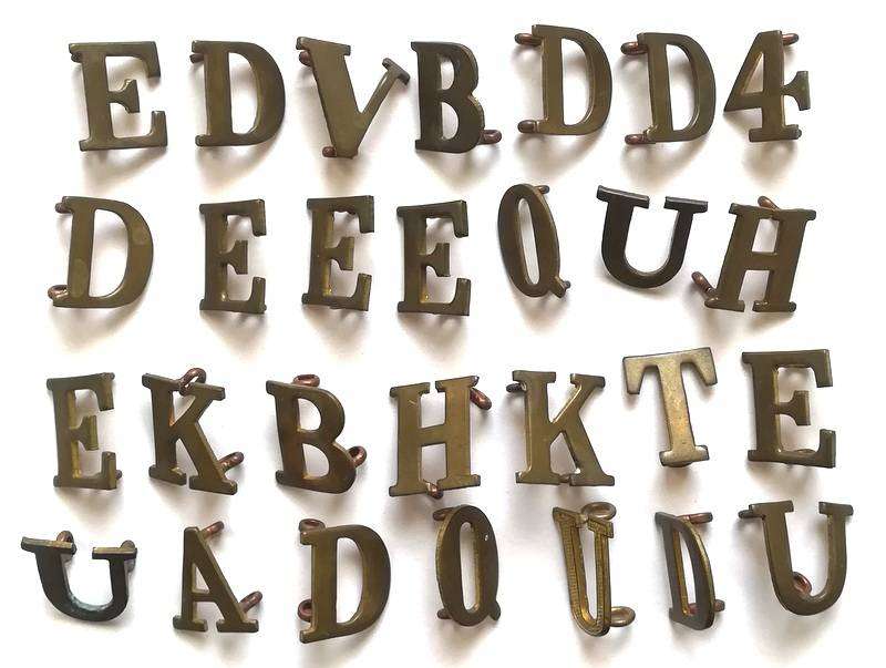 APPROXIMATELY 75 BRASS MILITARY LETTERS