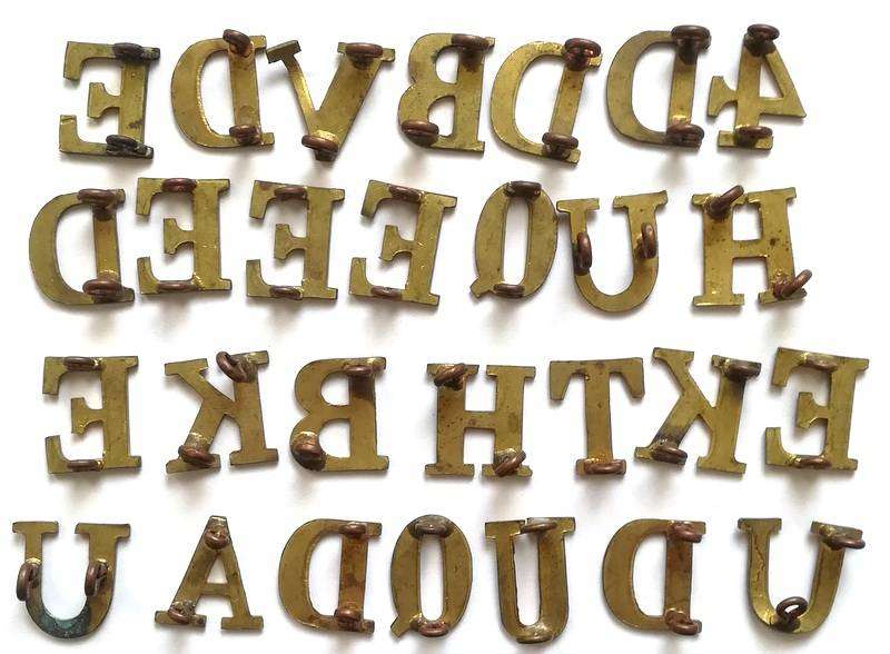 APPROXIMATELY 75 BRASS MILITARY LETTERS