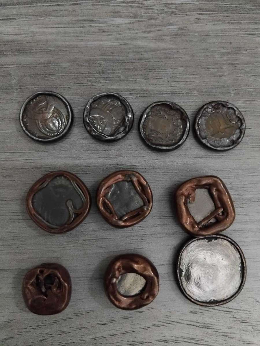 Coins: RSA 10 cents & R1. Damaged by heat in tumble dryer.