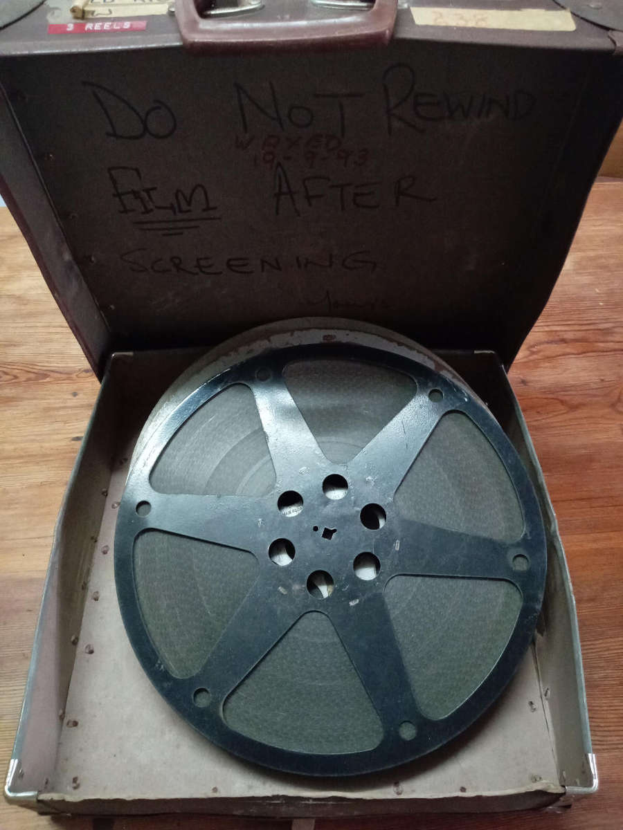 16mm MOVIE REELS IN CASE. "" JUST A LITTLE INCONVENIENCE "