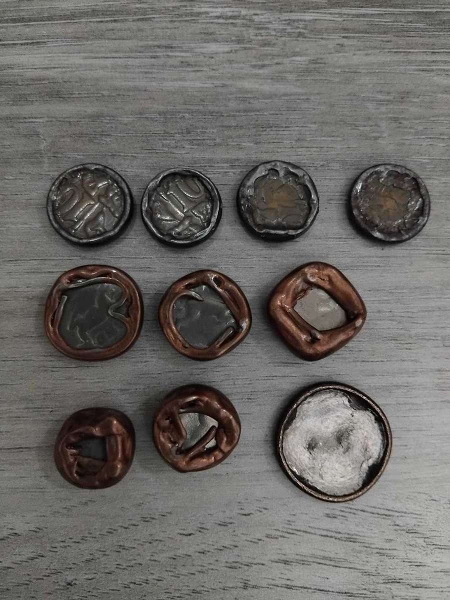 Coins: RSA 10 cents & R1. Damaged by heat in tumble dryer.