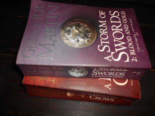 Two George Martin books - A strom of Swords & a Feast of Crows paperbacks