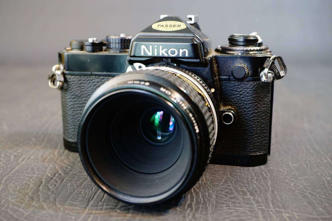 Black Nikon FE 35mm SLR Camera with Nikon Micro Nikkor 55mm F3.5 Lens