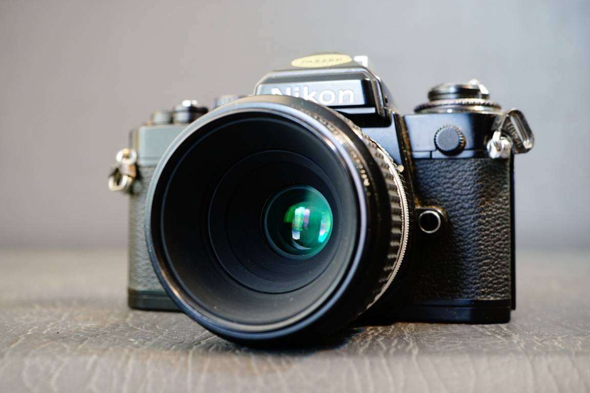 Black Nikon FE 35mm SLR Camera with Nikon Micro Nikkor 55mm F3.5 Lens