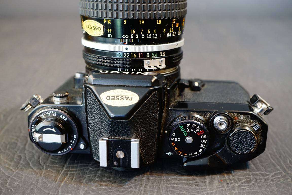 Black Nikon FE 35mm SLR Camera with Nikon Micro Nikkor 55mm F3.5 Lens