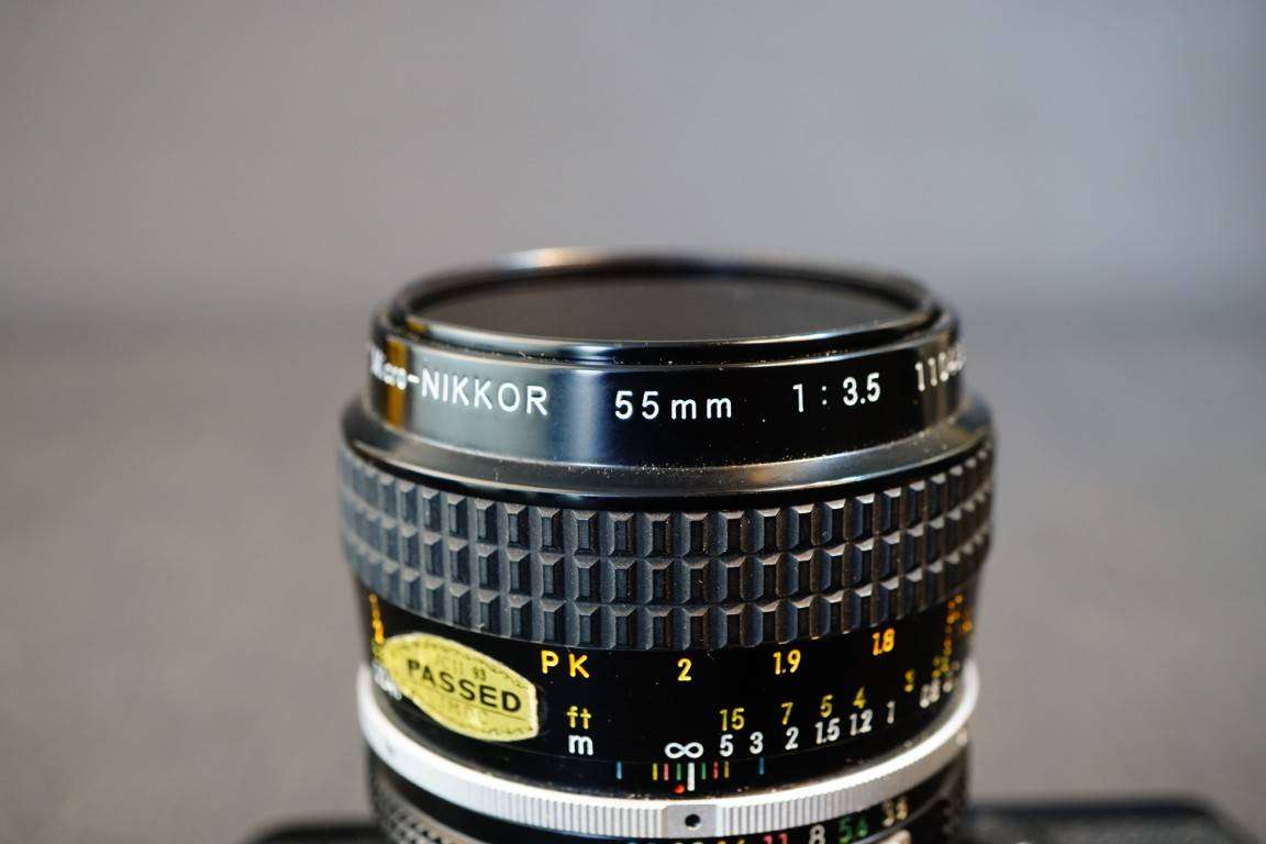 Black Nikon FE 35mm SLR Camera with Nikon Micro Nikkor 55mm F3.5 Lens