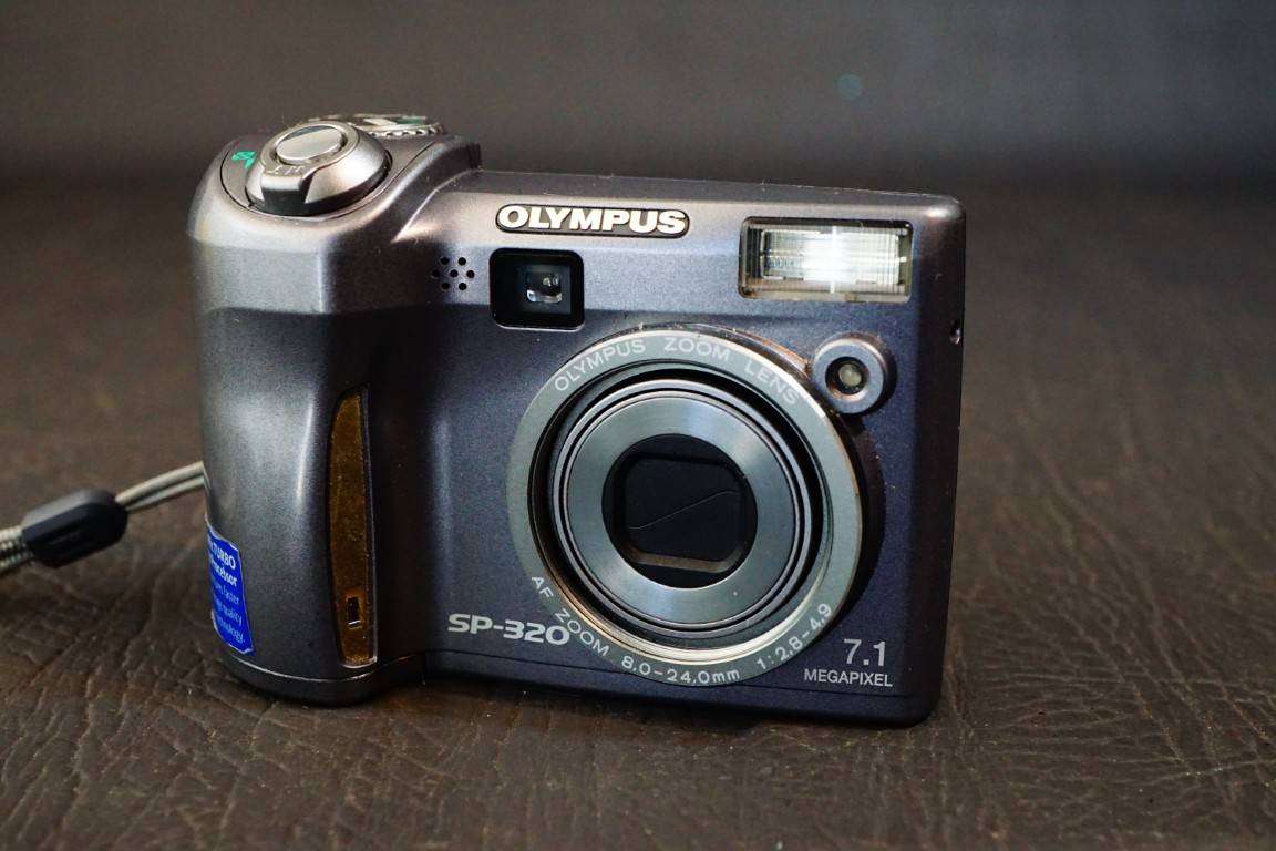 Olympus SP Series SP-320 7.1MP Digital Camera 3x Optical Zoom uses AA Batteries  **Good Condition**