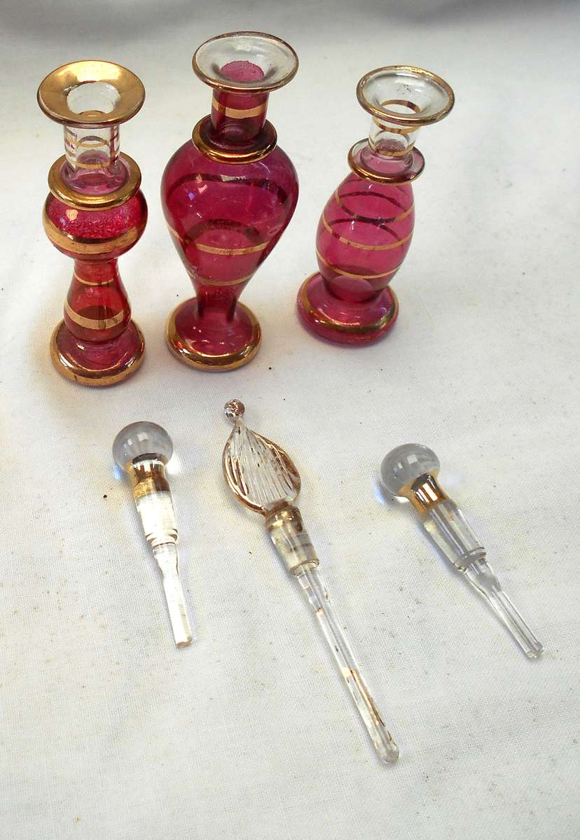 STUNNING three MINIATURE ROSE COLOUR EGYPTIAN GLASS PERFUME BOTTLES WITH DAPPERS