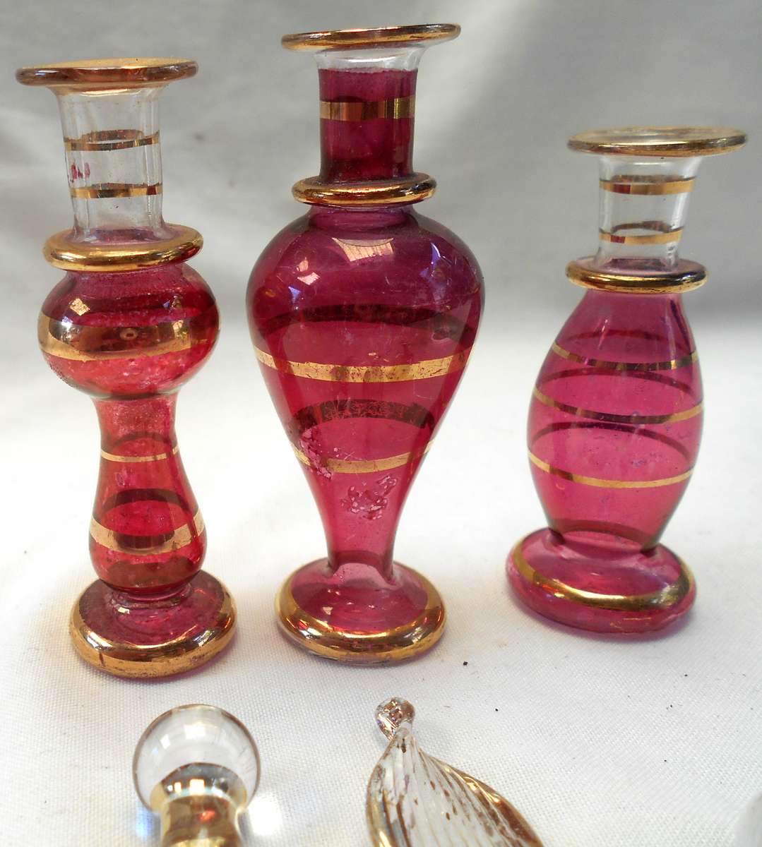 STUNNING three MINIATURE ROSE COLOUR EGYPTIAN GLASS PERFUME BOTTLES WITH DAPPERS