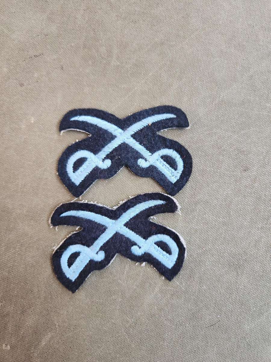 Pair of new & unused SADF era SAAF NCO Instructors (PTIs?) crossed swords badges for rank brassards