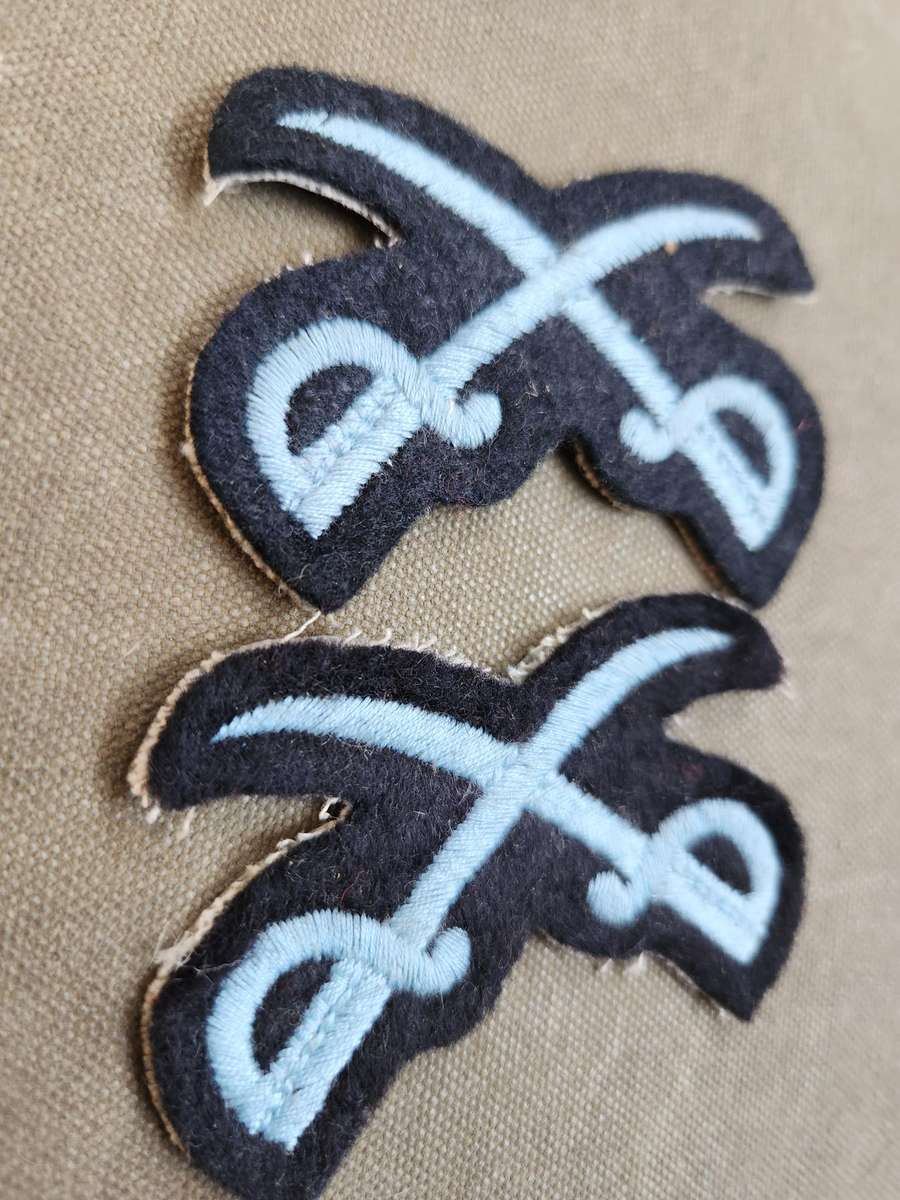 Pair of new & unused SADF era SAAF NCO Instructors (PTIs?) crossed swords badges for rank brassards