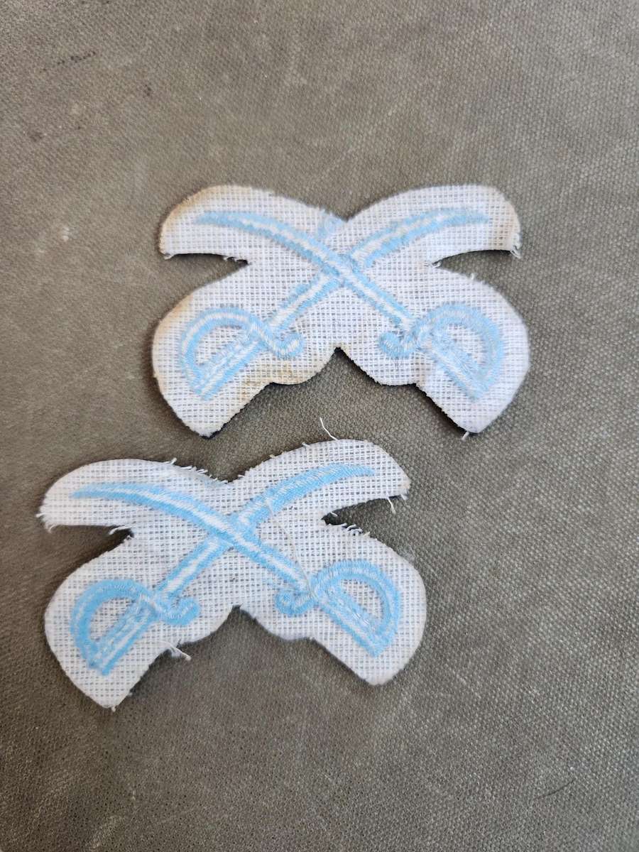 Pair of new & unused SADF era SAAF NCO Instructors (PTIs?) crossed swords badges for rank brassards