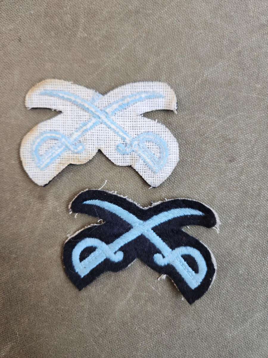 Pair of new & unused SADF era SAAF NCO Instructors (PTIs?) crossed swords badges for rank brassards