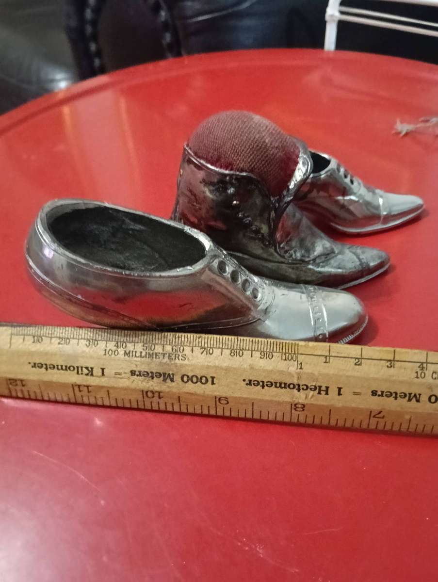 VINTAGE SILVER-TONE METAL PIN CUSHION SHOES.