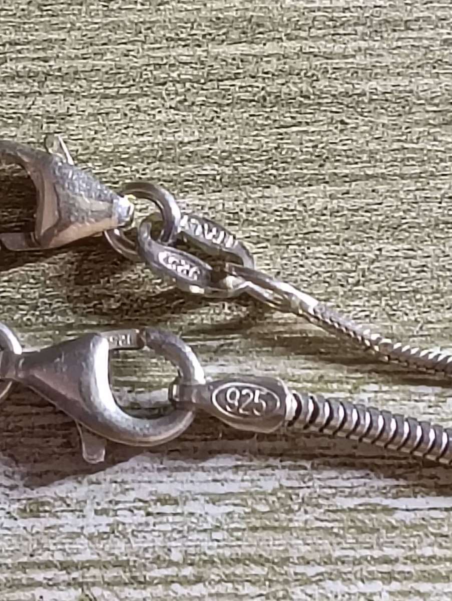 SILVER NECKLACES, WITH CLAW PENDANT.