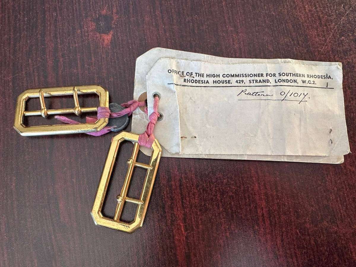 Rhodesian belt buckles with sealed card.