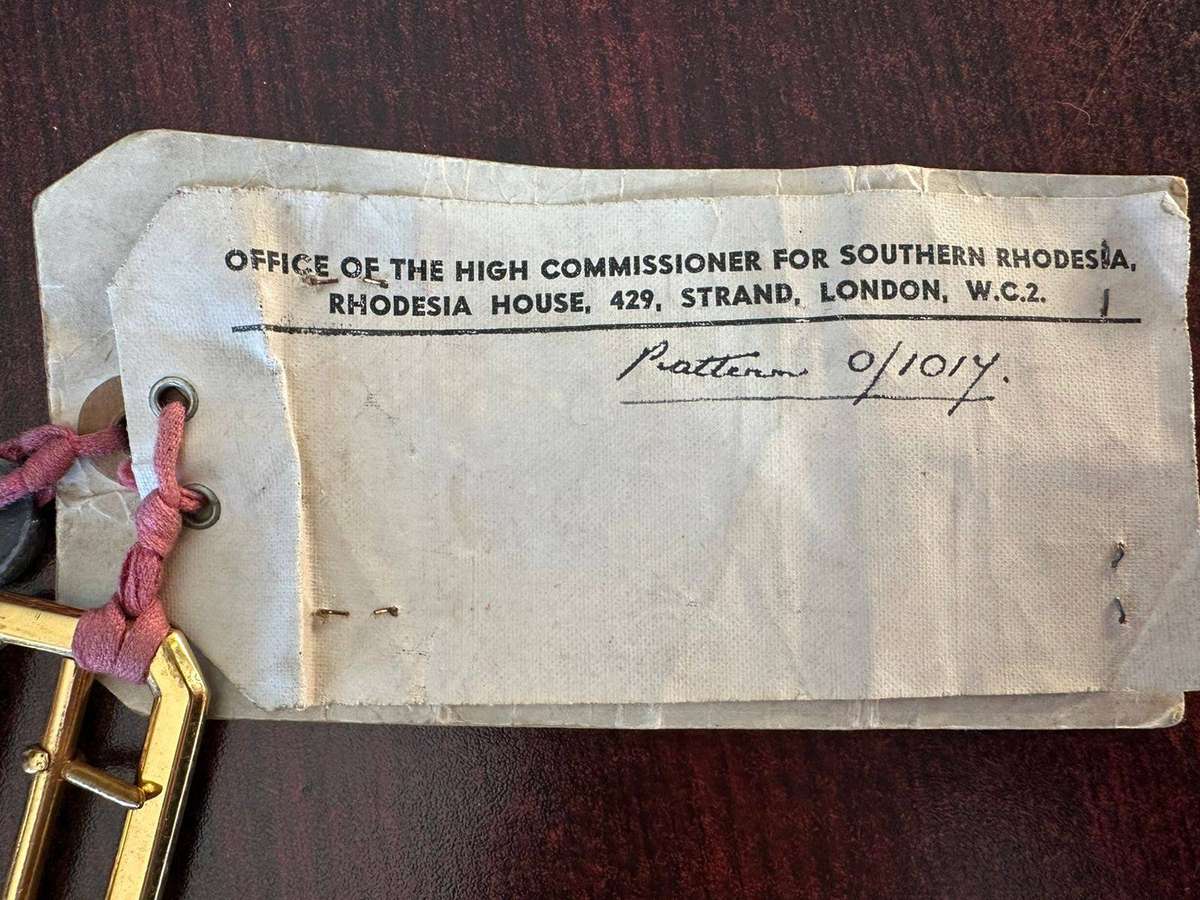 Rhodesian belt buckles with sealed card.