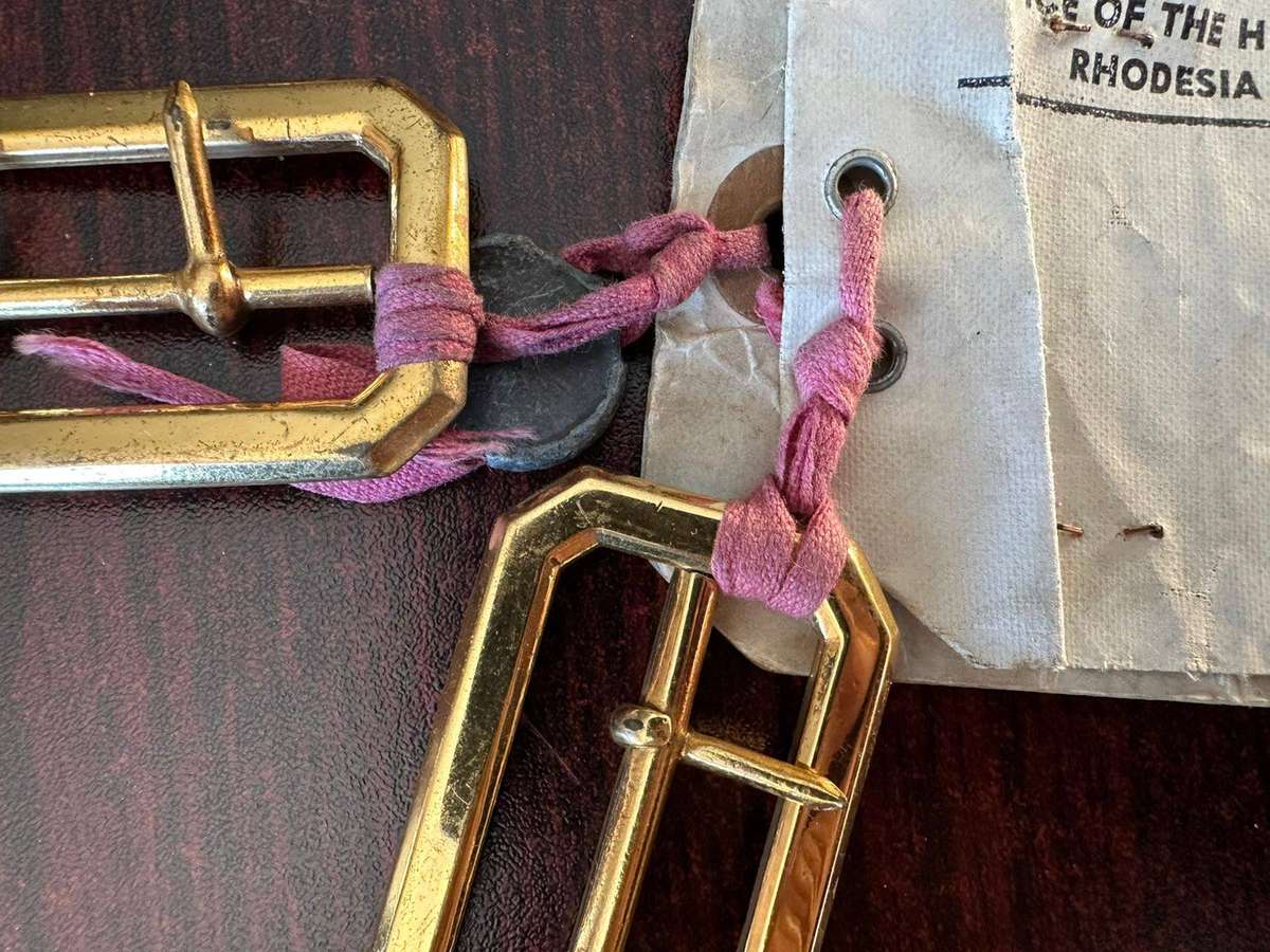 Rhodesian belt buckles with sealed card.