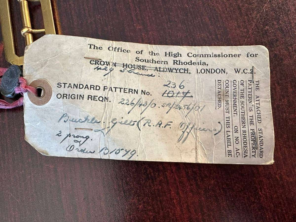 Rhodesian belt buckles with sealed card.