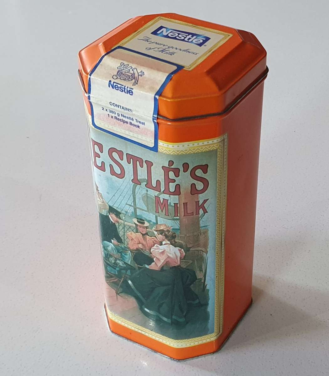 NESTLE tin as per photos