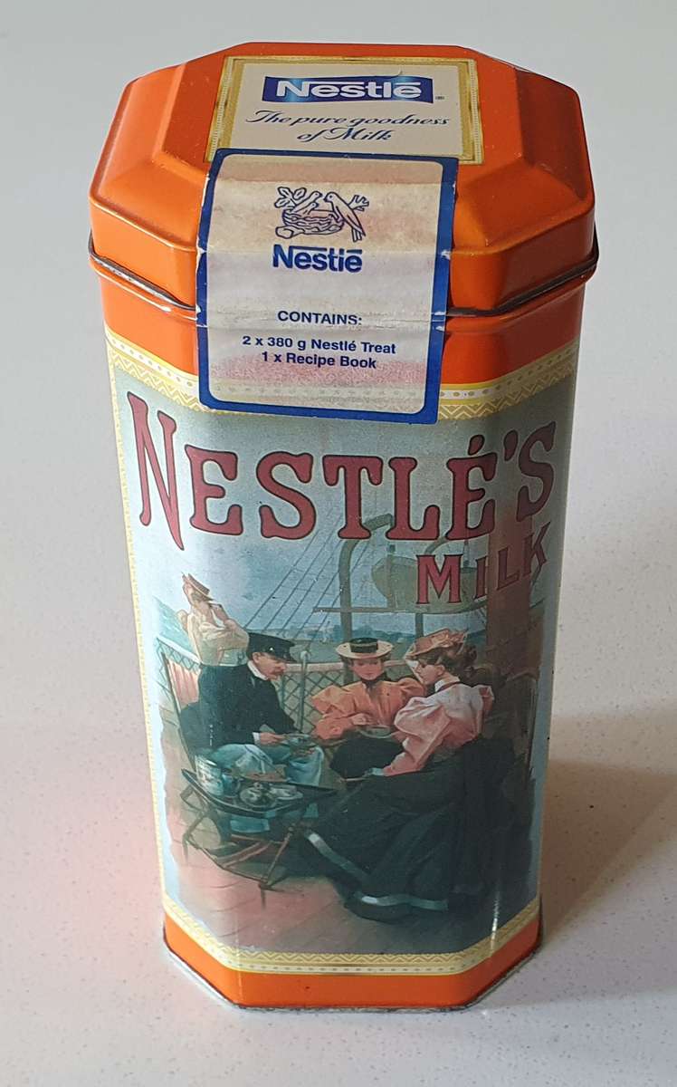 NESTLE tin as per photos